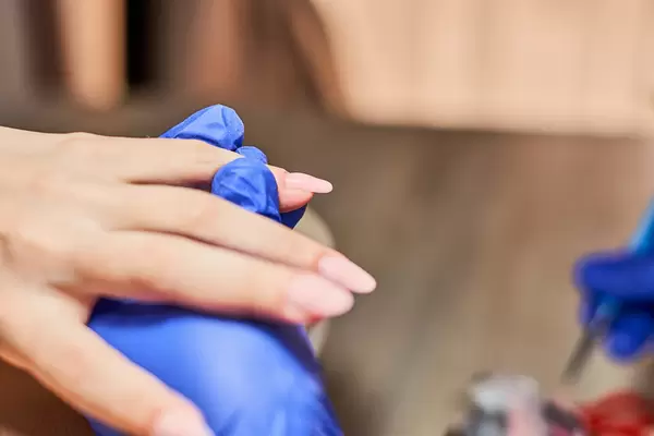 Woman in beauty spa salon doing manicure