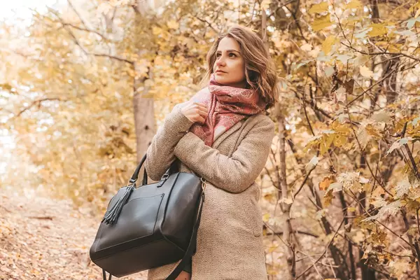 Woman in coat in autumn park