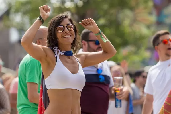 Woman in sunglasses dancing at the first day of Tomorrowland