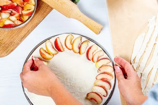 Woman preparing homemade peach pie (Flip 2019)