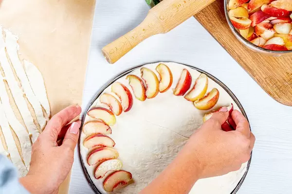 Woman preparing homemade peach pie