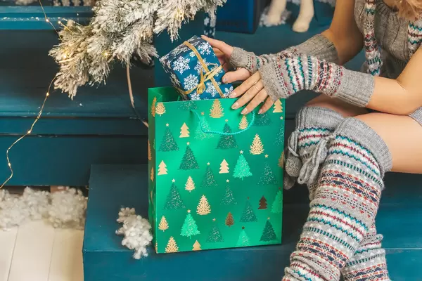 Woman puts box in new year gift bag