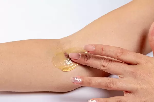 Woman putting medical gel on the bruise after intravenous blood sampling (Flip 2019)