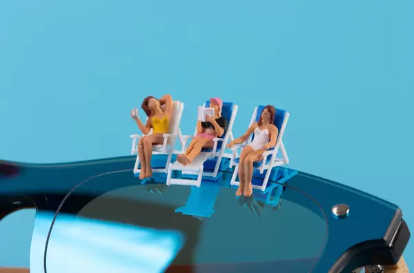 Woman sitting in deck chairs on top of the sunglasses