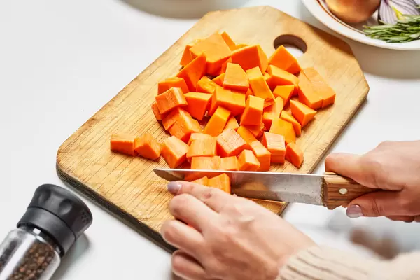Woman slicing carrots