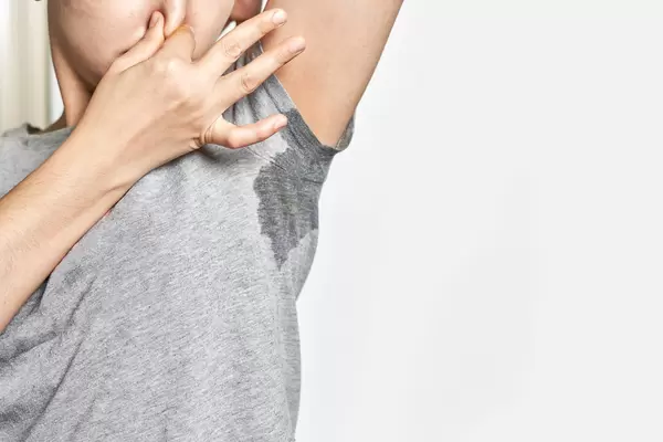 Woman sweating badly under armpit