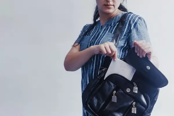 Woman taking sanitary napkins from her bag