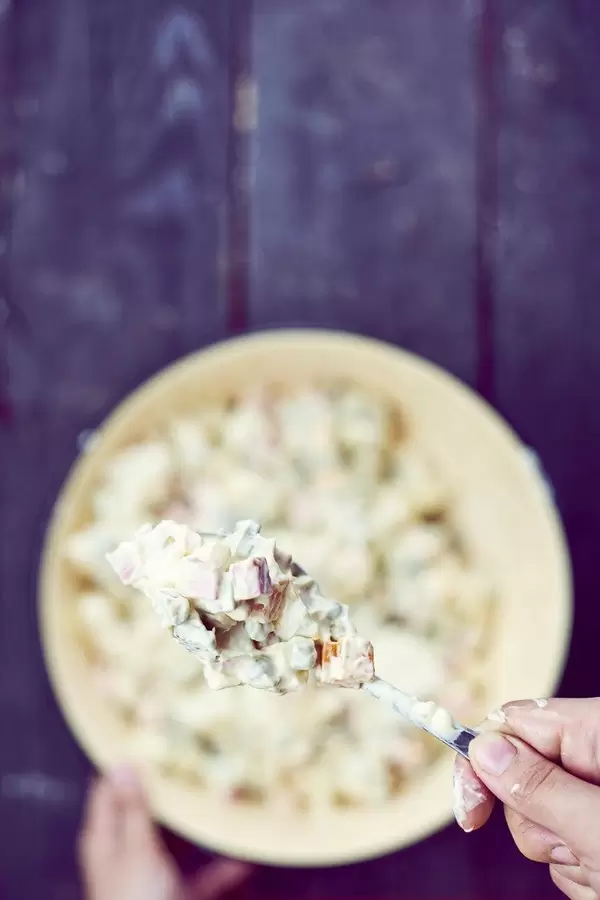 Woman tasting Olivier salad