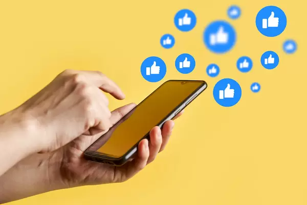 Woman using smartphone with notification icons of like