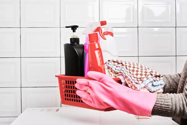 Woman with basket of cleaning supplies