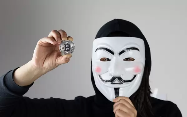 Woman with mask holding Bitcoin