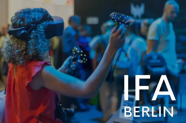 Woman with VR-Glasses on a Computer fair, next to picture title "IFA BERLIN"