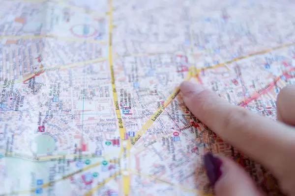 Woman's finger pointing at Bucharest City Map
