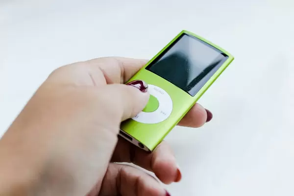 Woman's hand holding green ipod