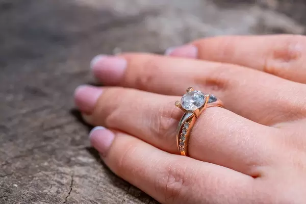 Woman's hand with a gold ring on her finger