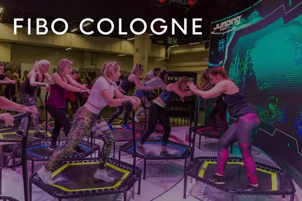 Women in sports clothes on trampolines for a jumping workout session at Fibo Cologne