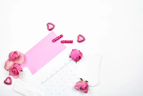 Women's calendar and flowers on a white background