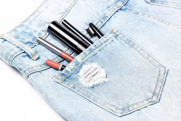 Women's cosmetics in the pocket of jeans