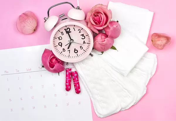 Women's cycle hygienic pads and tampons on pink