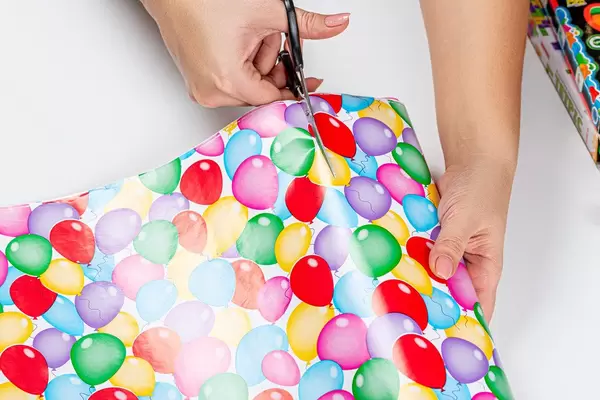 Women's hands cut paper for gift box packaging