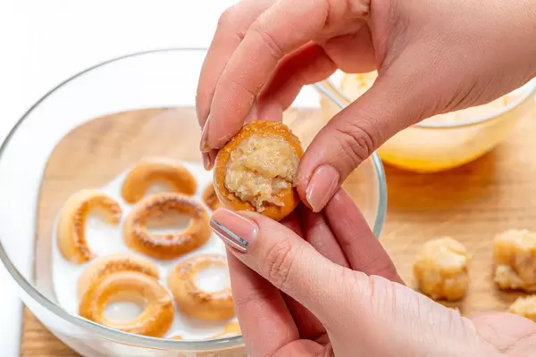 Women's hands stuffed bagel minced meat