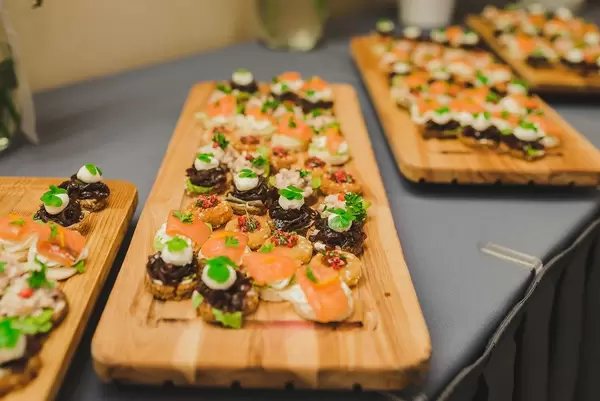 Wood Plates Of Salmon, Pork and Cream Canapes (Flip 2019)