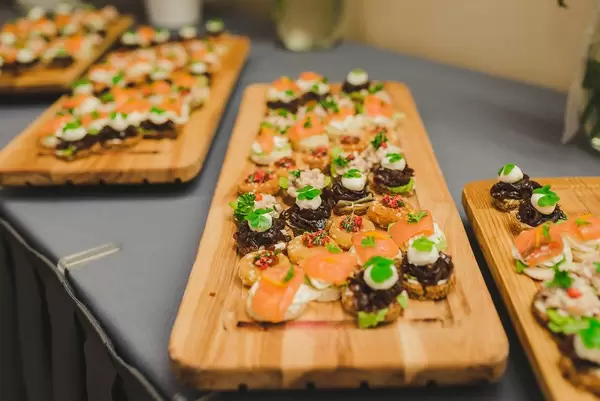 Wood Plates Of Salmon, Pork and Cream Canapes