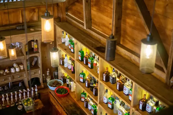 Wooden Bar with many kinds of Liquor, Syrup and other Ingredients for Cocktails