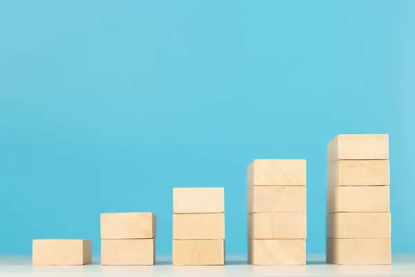 Wooden blocks in shape of a ladder, business growth concept