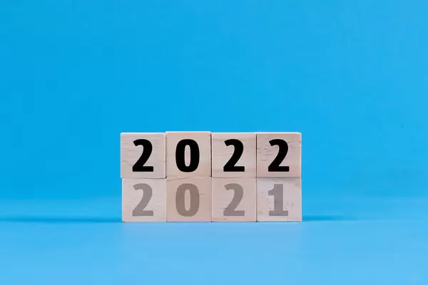 Wooden blocks with 2021 and 2022 text on blue background