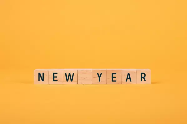 Wooden blocks with New Year text on yellow background