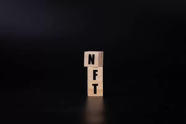 Wooden blocks with NFT text on black background