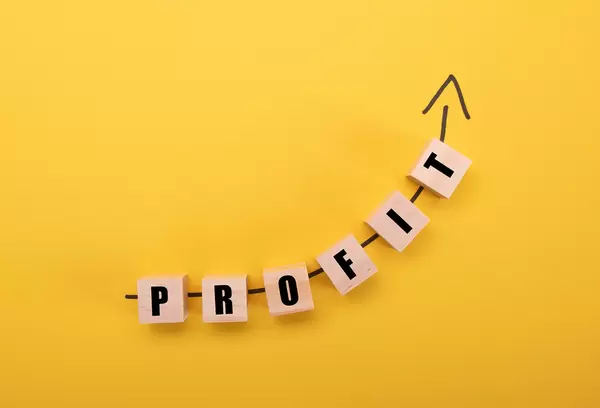 Wooden blocks with Profit text on yellow background