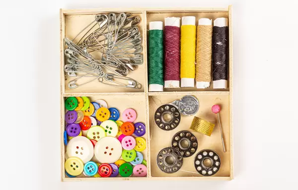 Wooden box with a set of sewing accessories, top view