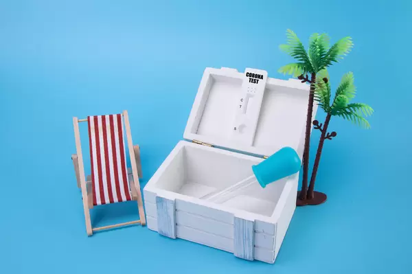 Wooden box with Coronavirus test and Vacation 2021 text