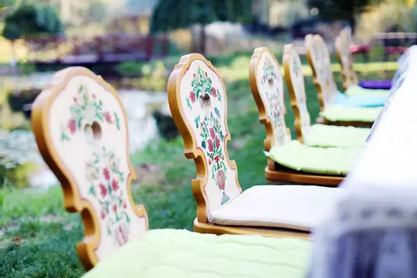 Wooden chairs with traditional motifs, closeup view (Flip 2019)