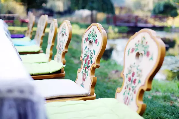 Wooden chairs with traditional motifs, closeup view