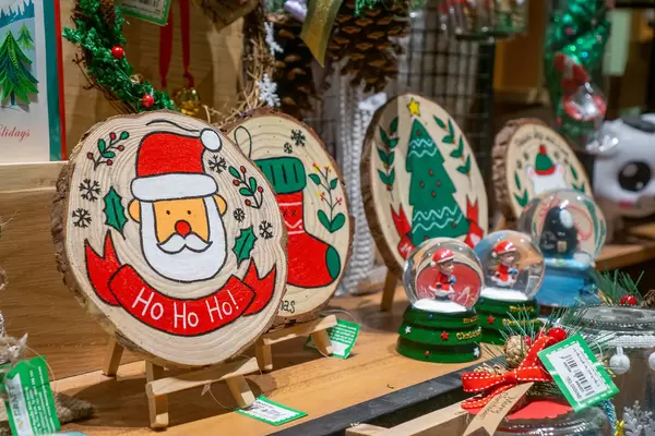Wooden Christmas Decorations, Festive Wreaths and Snow Globes for Sale in a Store