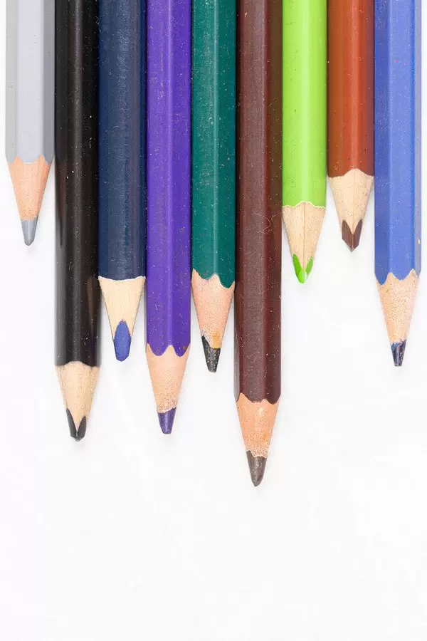 Wooden Color Pencils stacked with copy space above white background