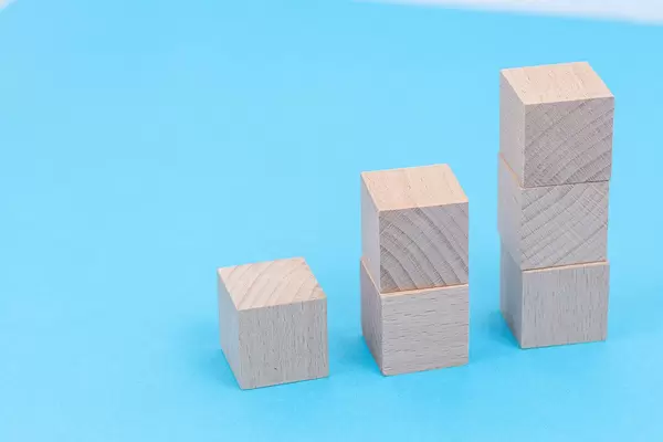 Wooden Cubes stairs with copy space above blue background