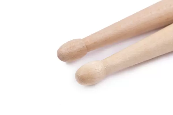 Wooden Drumsticks in closeup image with copy space above white