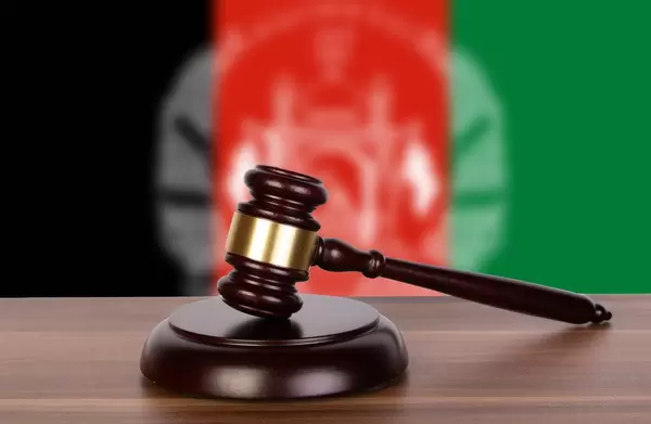 Wooden gavel and flag of Afghanistan