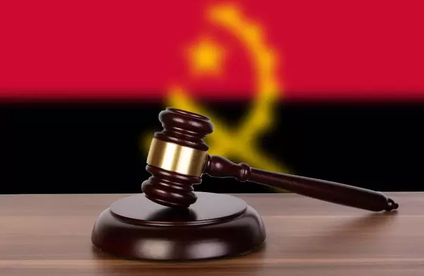 Wooden gavel and flag of Angola