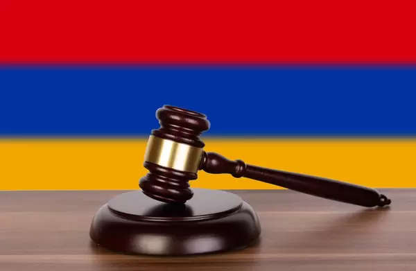 Wooden gavel and flag of Armenia