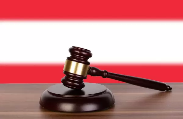 Wooden gavel and flag of Austria