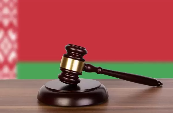 Wooden gavel and flag of Belarus