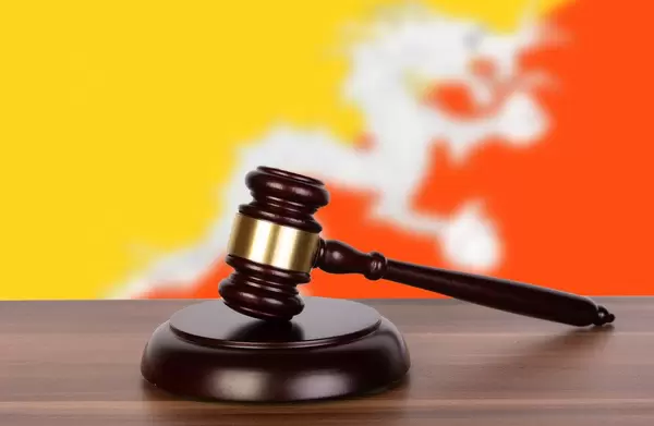 Wooden gavel and flag of Bhutan