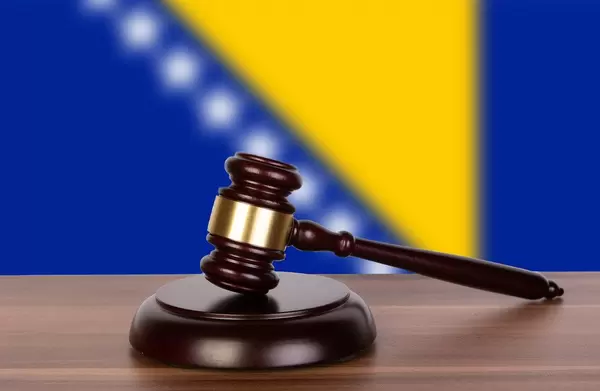 Wooden gavel and flag of Bosnia and Herzegovina