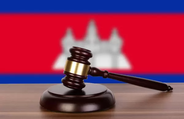 Wooden gavel and flag of Cambodia