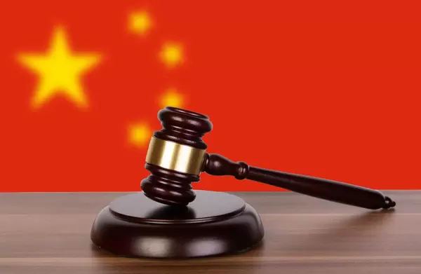 Wooden gavel and flag of China